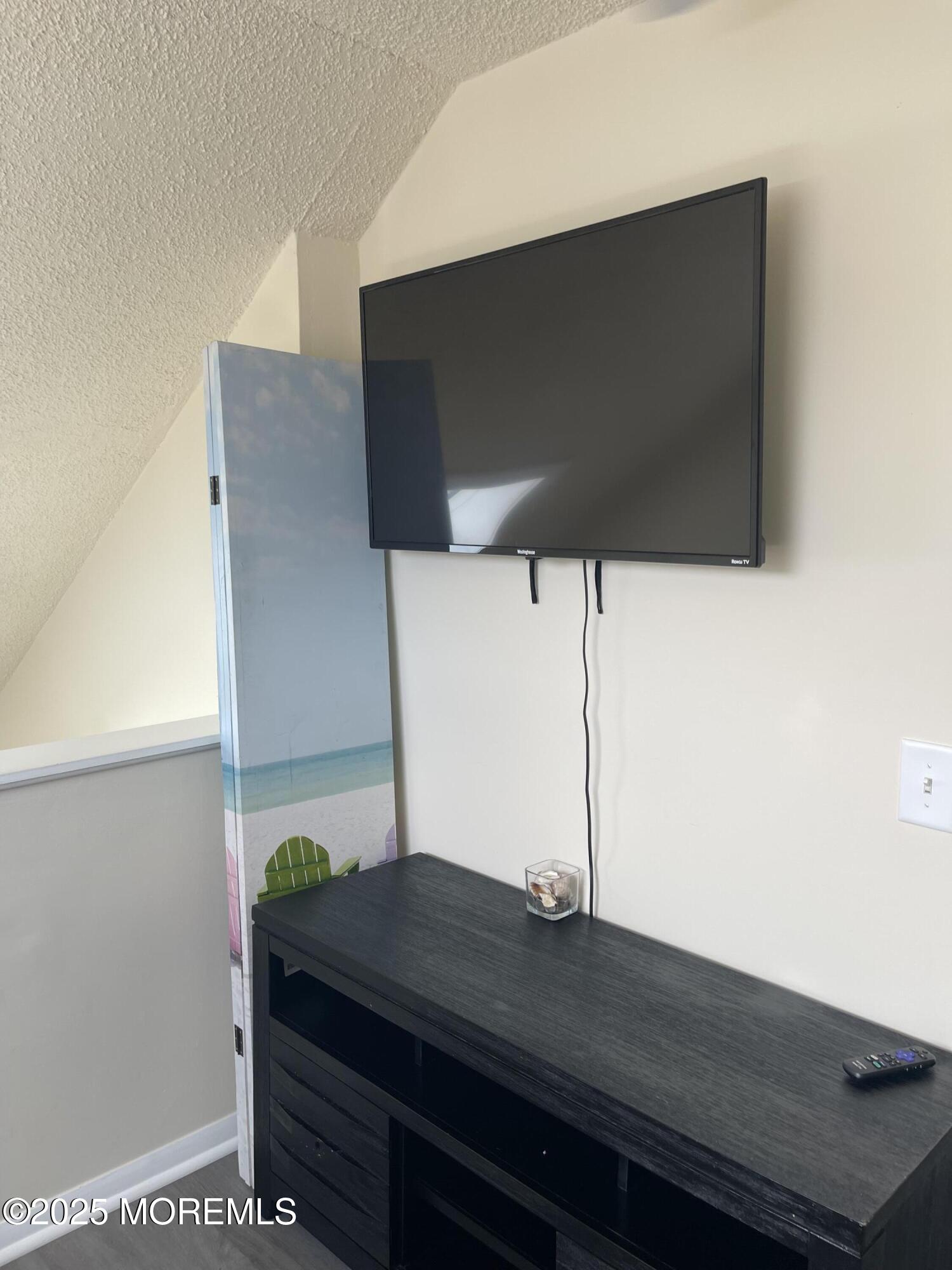 202 Carteret Avenue, Unit B5 Seaside Heights, NJ 08751 - Photo 7 of 17 a room with a table and a potted plant