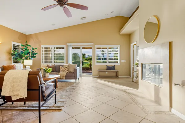 a living room with furniture and a floor to ceiling window