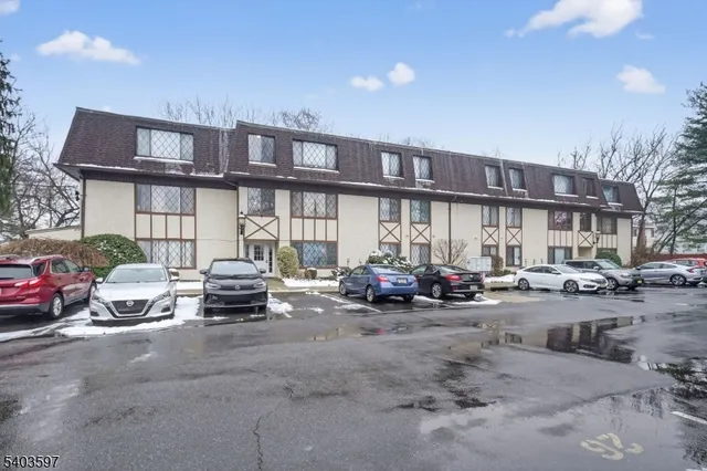 a view of a cars park in front of a building