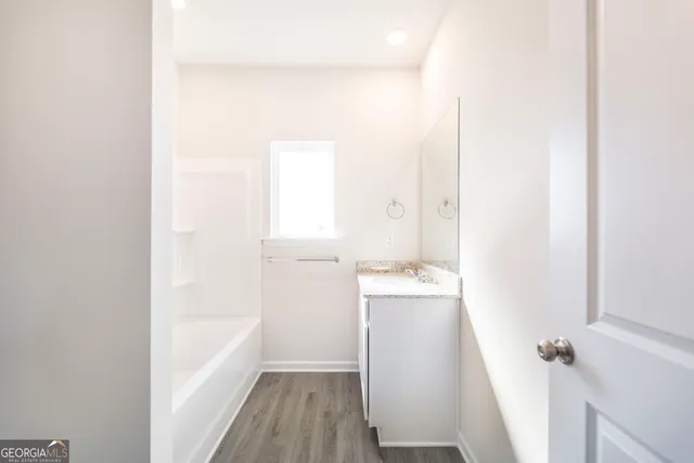 a view of hallway with wooden floor