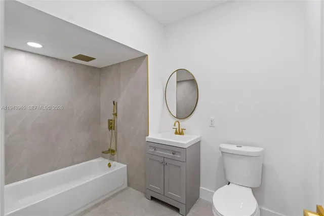 a bathroom with a toilet a sink and bathtub