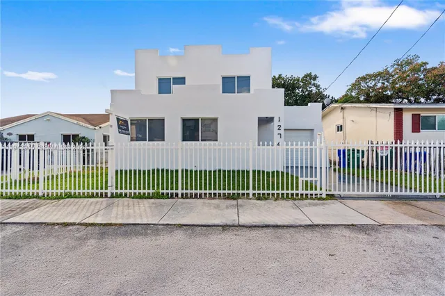 a view of a house with a wooden fence