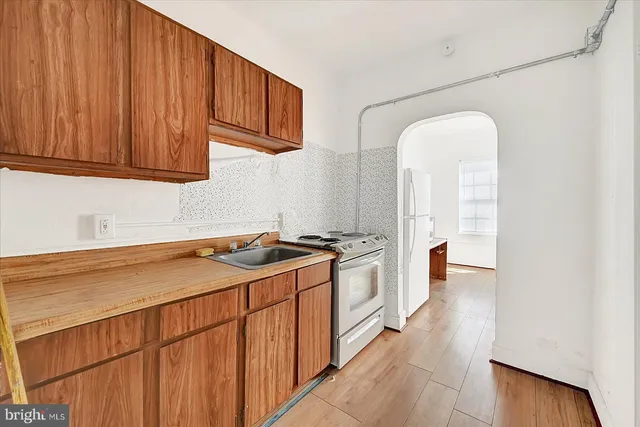 a kitchen that has a sink and a stove