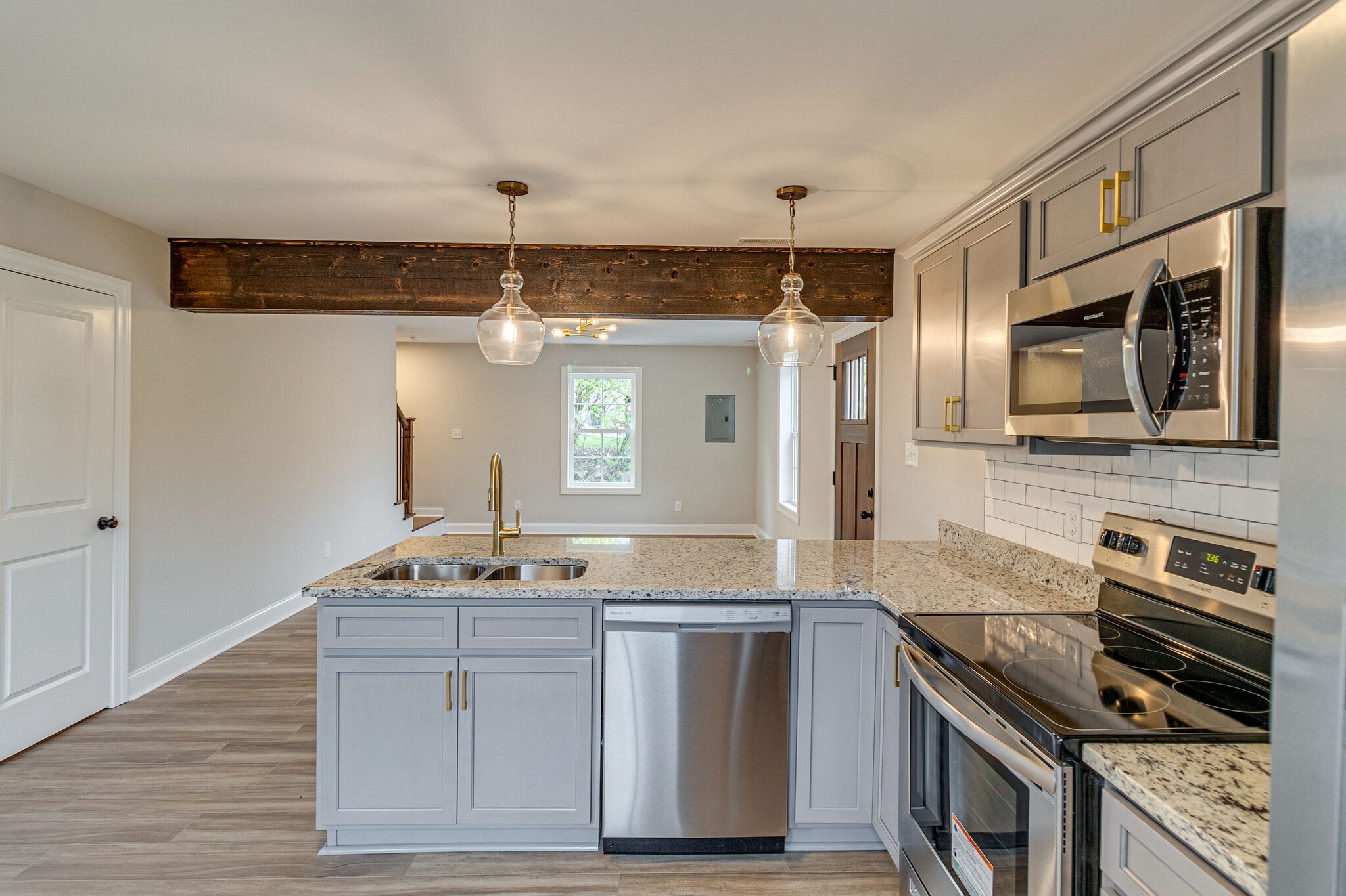 1008 Beckett Street, Unit A Columbia, TN 38401 - Photo 13 of 29 a kitchen with stainless steel appliances kitchen island granite countertop a stove and a sink