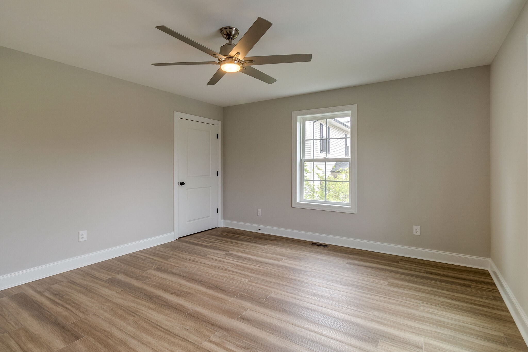 1008 Beckett Street, Unit A Columbia, TN 38401 - Photo 19 of 29 a view of an empty room with wooden floor and a window