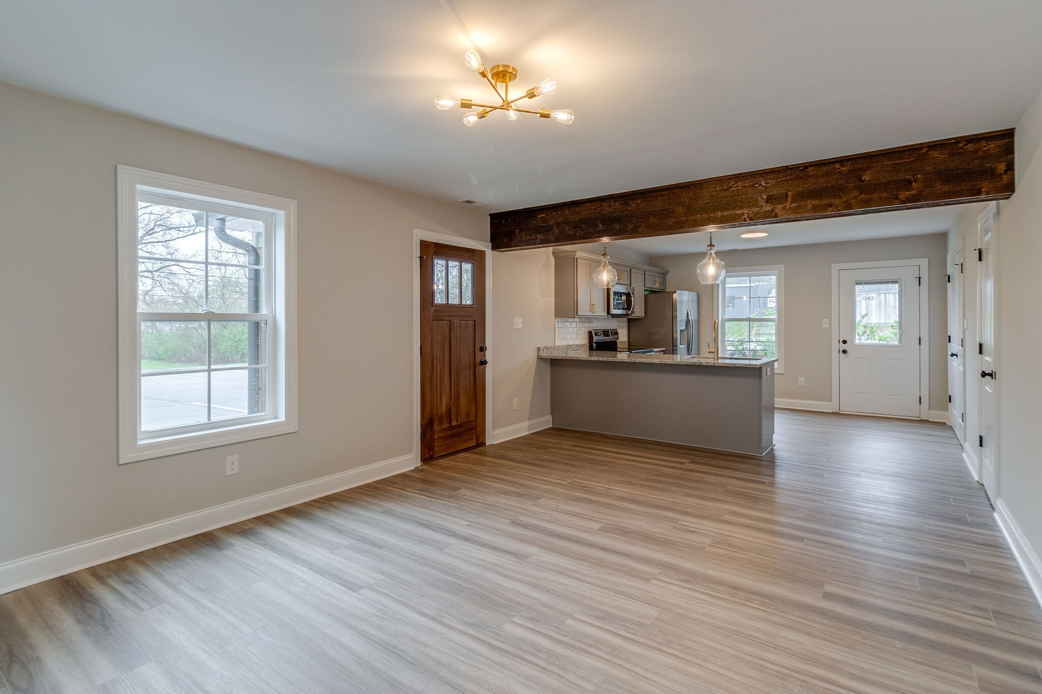 1008 Beckett Street, Unit A Columbia, TN 38401 - Photo 7 of 29 wooden floor in an empty room with a window