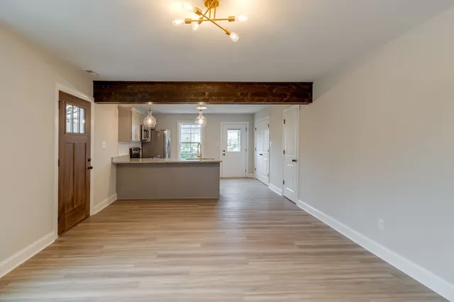 a view of a kitchen with a sink and cabinets