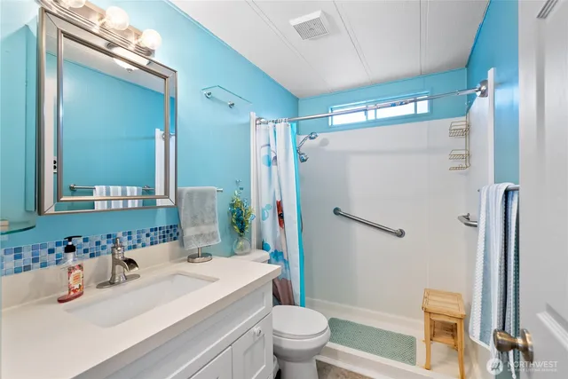 a bathroom with a sink toilet and shower