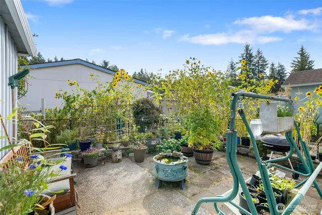 a view of a backyard with sitting area and garden
