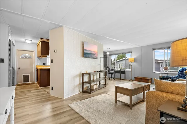 a living room with furniture wooden floor and a fireplace