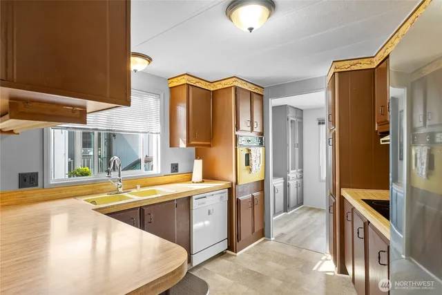a view of a kitchen with a tub and windows