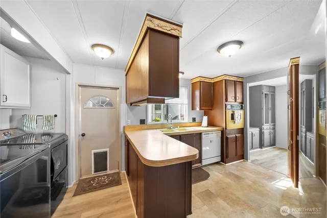 a kitchen with a sink stove and refrigerator