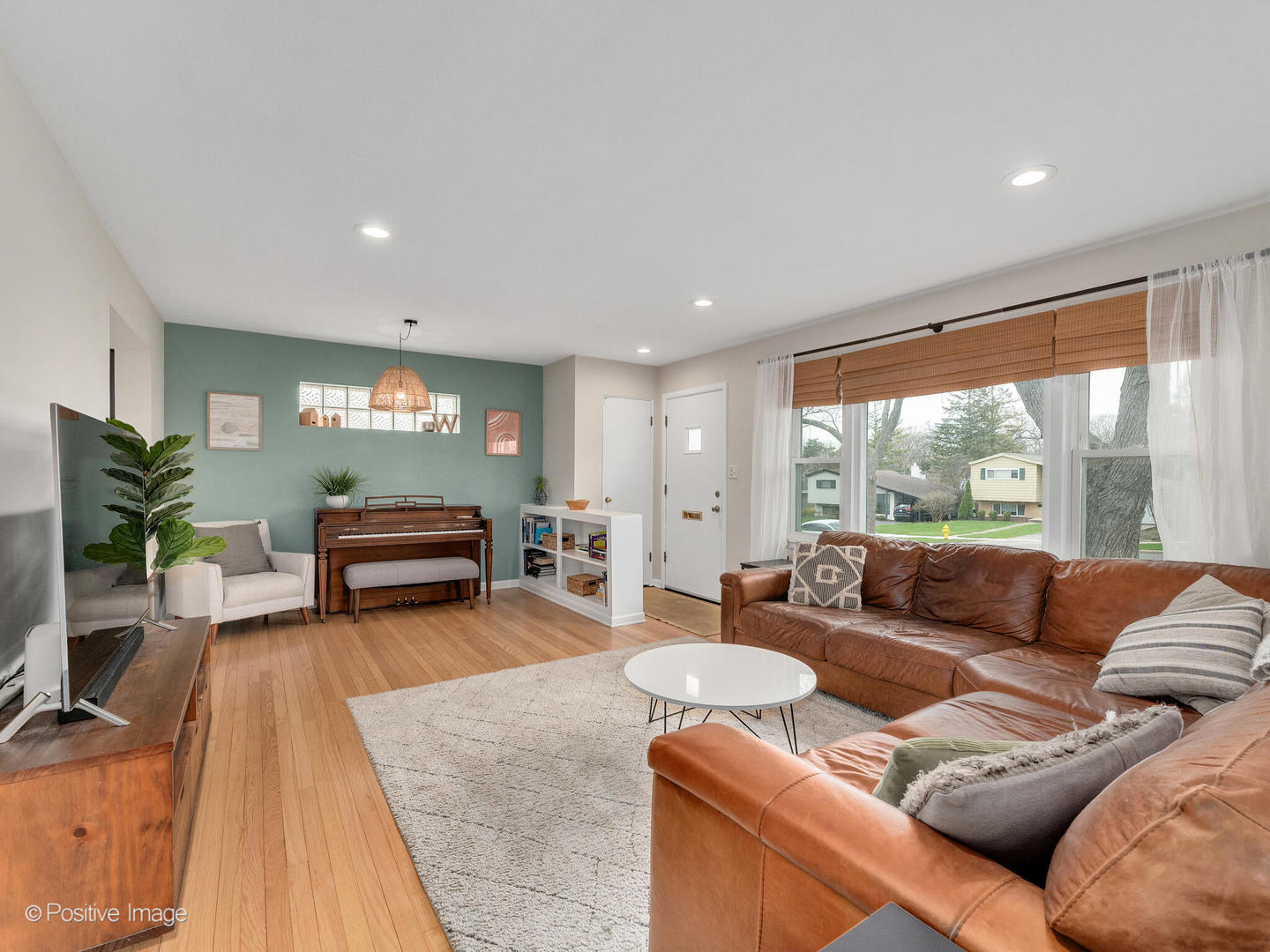 503 Kipling Court Wheaton, IL 60187 - Photo 3 of 27 a living room with furniture and a flat screen tv with wooden floor