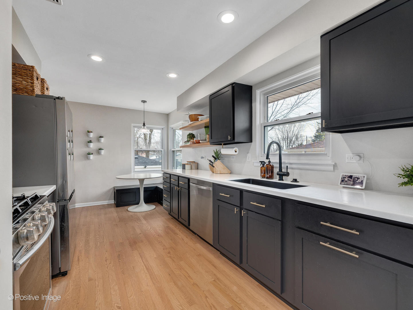 503 Kipling Court Wheaton, IL 60187 - Photo 7 of 27 a kitchen with stainless steel appliances a sink dishwasher a stove top oven a refrigerator with wooden floor