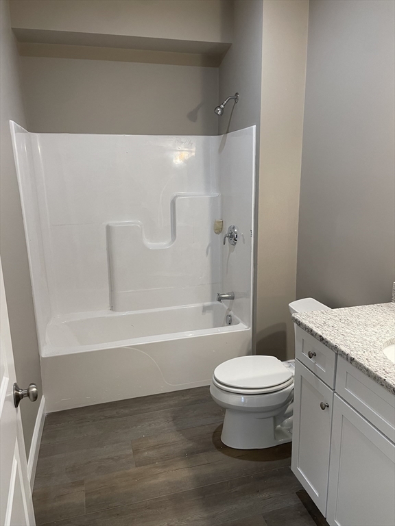 1 Brattle Street, Unit 1 Worcester, MA 01606 - Photo 13 of 21 a bathroom with a granite countertop toilet a sink and a bathtub