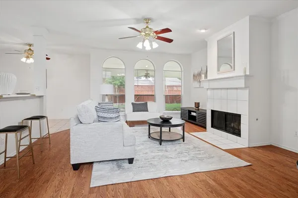 a living room with furniture fireplace and wooden floor