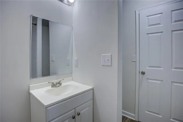 a bathroom with a sink toilet and mirror
