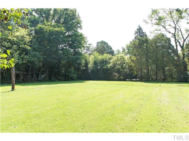 106 North King Charles Road Raleigh, NC 27610 - Photo 22 of 25 Incredible Flat Landscape In This Beautiful Backyard. The Lot Is Approximately .64 Acre. Fun Activities And Space For a Garden Await You. The Song Of The Birds Is Delightful Here! Create Your Own Garden Or Backyard Oasis.