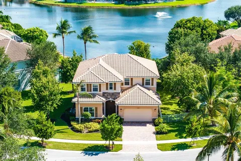 an aerial view of a house with swimming pool and garden