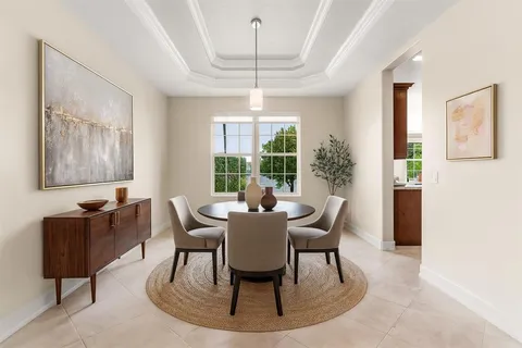 a dining room with furniture a chandelier and window