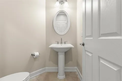 a bathroom with a toilet a sink and a mirror