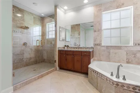 a bathroom with a bathtub shower and sink