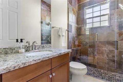 an aerial view of residential house with outdoor space and swimming pool