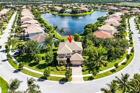an aerial view of residential houses with outdoor space and swimming pool