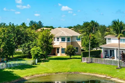 an aerial view of a house with a yard pool patio and outdoor seating
