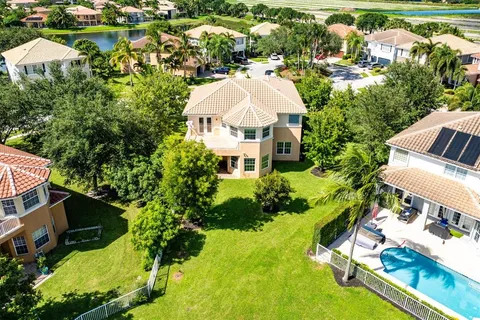 a view of a house with a yard and sitting area