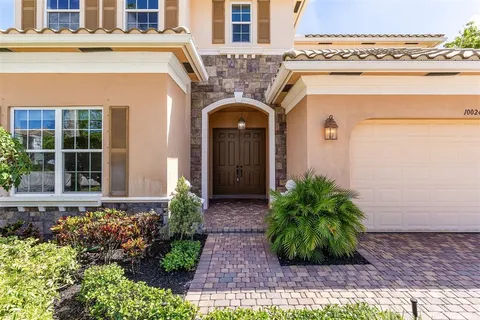 front view of a house with potted plants