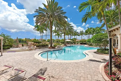a view of a house with swimming pool and sitting area