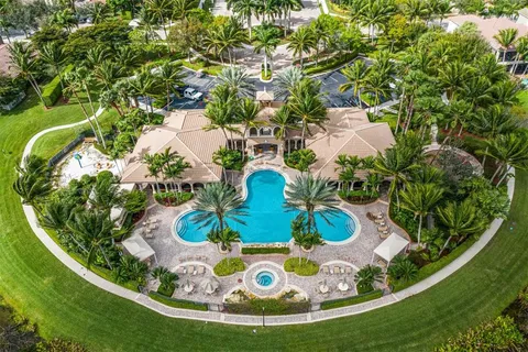 a view of a house with swimming pool and sitting area
