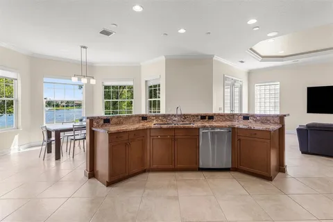 a kitchen with a large counter top space appliances and windows