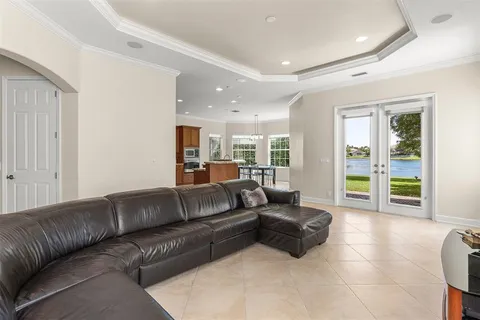 a living room with furniture and large windows