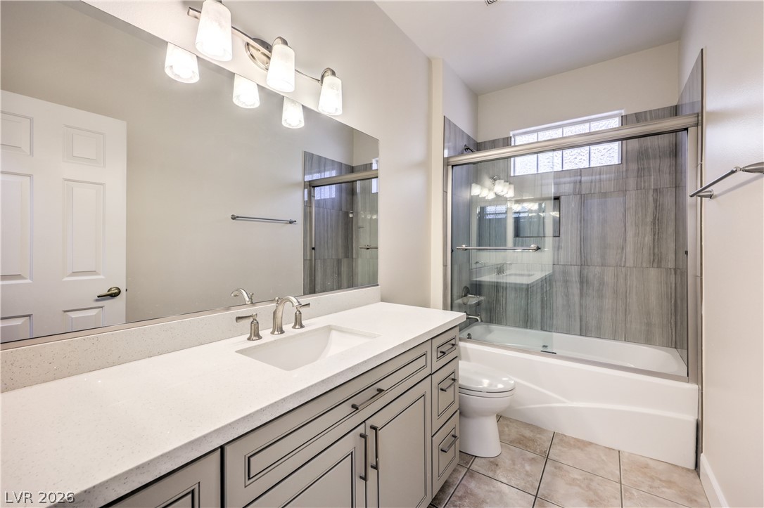 2050 West Warm Springs Road, Unit 1421 Henderson, NV 89014 - Photo 33 of 45 A well-appointed bathroom features a spacious vanity with an integrated sink and a sleek tub-shower combination.