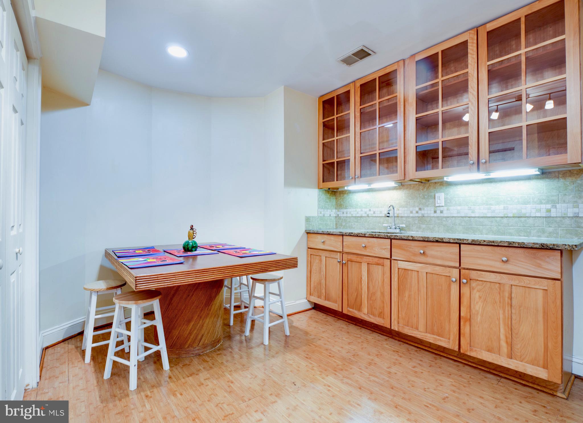 6306 Valley Road Bethesda, MD 20817 - Photo 60 of 74 a dinning table and chairs in a kitchen