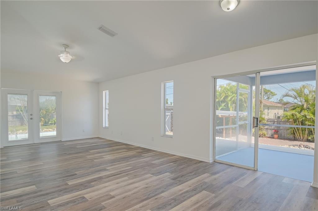 18441 Columbine Road Fort Myers, FL 33967 - Photo 12 of 33 an empty room with wooden floor and windows