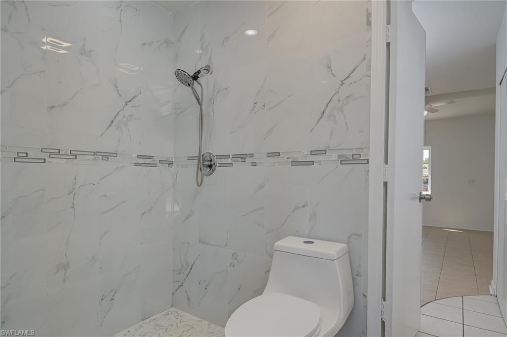 18441 Columbine Road Fort Myers, FL 33967 - Photo 19 of 33 a white toilet sitting next to a bathroom sink