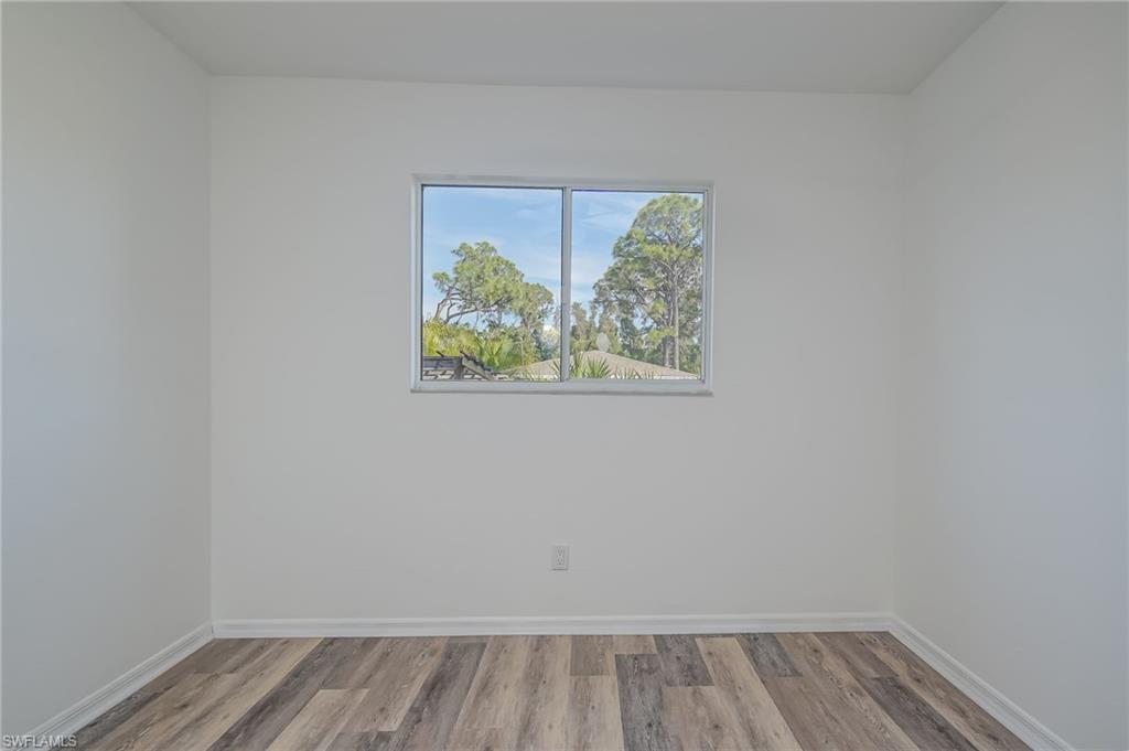 18441 Columbine Road Fort Myers, FL 33967 - Photo 22 of 33 a view of an empty room with wooden floor and a window