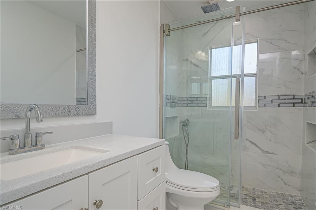 18441 Columbine Road Fort Myers, FL 33967 - Photo 24 of 33 a bathroom with a sink a toilet and shower