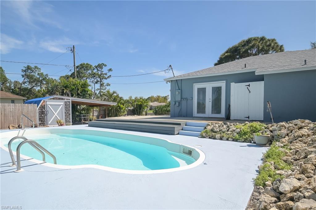 18441 Columbine Road Fort Myers, FL 33967 - Photo 25 of 33 a view of a house with a swimming pool and a yard
