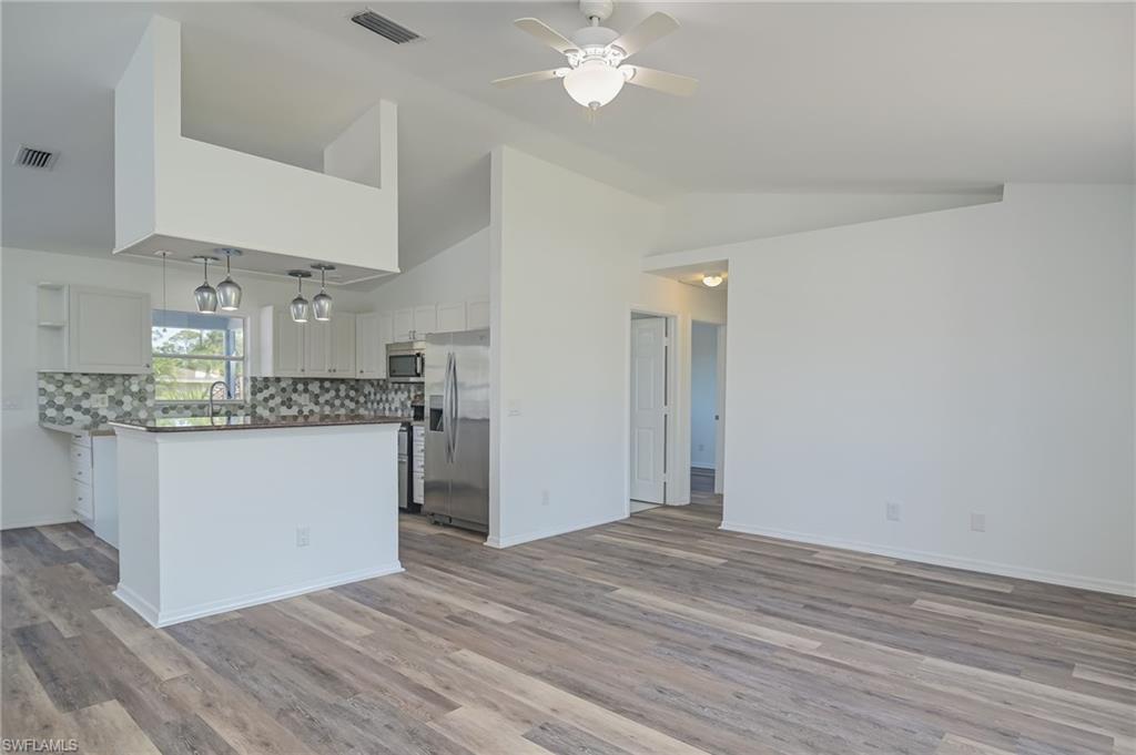 18441 Columbine Road Fort Myers, FL 33967 - Photo 5 of 33 a view of kitchen cabinets and wooden floor