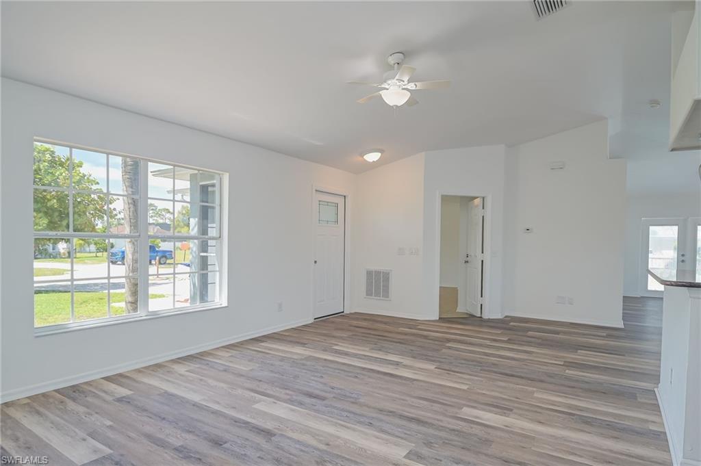 18441 Columbine Road Fort Myers, FL 33967 - Photo 7 of 33 a view of an empty room with wooden floor and a window