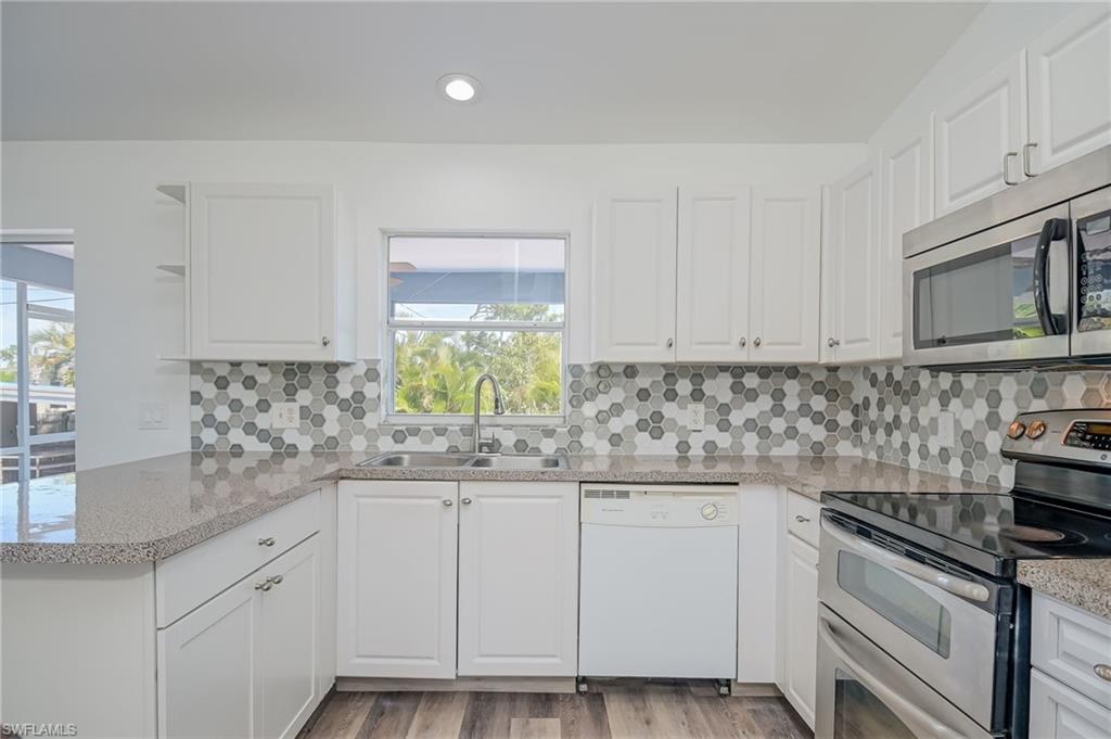 18441 Columbine Road Fort Myers, FL 33967 - Photo 8 of 33 a kitchen with granite countertop white cabinets and white appliances