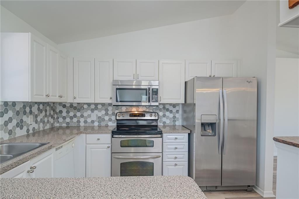 18441 Columbine Road Fort Myers, FL 33967 - Photo 9 of 33 a kitchen with appliances a sink and cabinets