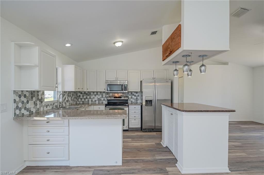 18441 Columbine Road Fort Myers, FL 33967 - Photo 10 of 33 a kitchen with a refrigerator and cabinets