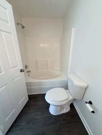 a bathroom with a toilet and a tub