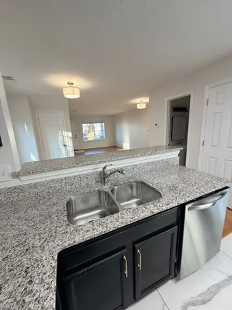 a bathroom with a granite countertop sink a mirror and vanity