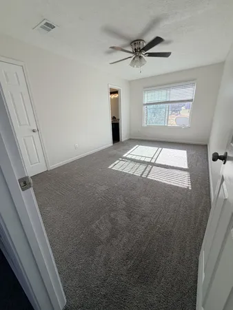 a view of an empty room and a window